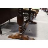 An early 20th century mahogany extending dining table with extra folding centre leaf and Wabash