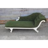 A late 19th century painted frame chaise longue with scroll arm, upholstered in a green Dralon, on