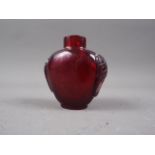A carved red Peking glass snuff bottle, 2 5/8" high
