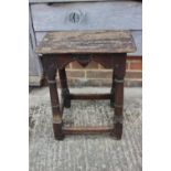 A largely 17th century oak joint stool, on turned and stretchered supports, 18" wide x 11" deep x