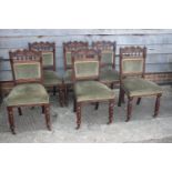 A set of six late 19th century carved walnut frame standard dining chairs with padded seats and