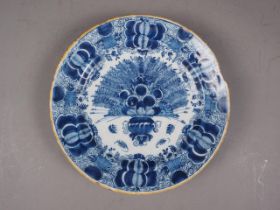 An 18th century Delft shallow bowl with vase of flowers decoration, 12" dia (rim chips)