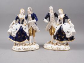 A pair of Japanese porcelain groups, figures in period costume with gilt decoration, 8" high