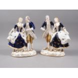 A pair of Japanese porcelain groups, figures in period costume with gilt decoration, 8" high