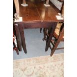 A Georgian oak drop leaf dining table, on moulded chamfered supports with brass castors, 40" wide