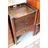 A mahogany tray top bedside cabinet, fitted one drawer over cupboard and one further drawers, on
