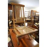 A late 19th century walnut folding cane seat and back chair