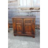 An oak panelled cupboard of 17th century design enclosed two doors, on stile supports, 38" wide x