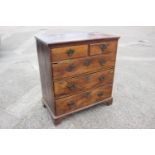 An 18th century fruitwood chest of two short and three long drawers with brass bale handles, on