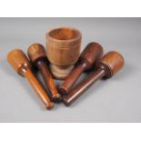 An antique turned lignum vitae mortar, 6" high, and a number of pestles