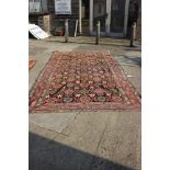 A Hamadan carpet of traditional design with all-over floral design on a dark ground and multi-