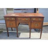 A mahogany and banded serpentine front sideboard, fitted three drawers over two cupboards, on square