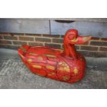 A red and gilt lacquered carved model of a duck, 27" long (cracked)