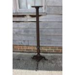 A mahogany torchere with fluted column, on tripod splay supports, 54" high