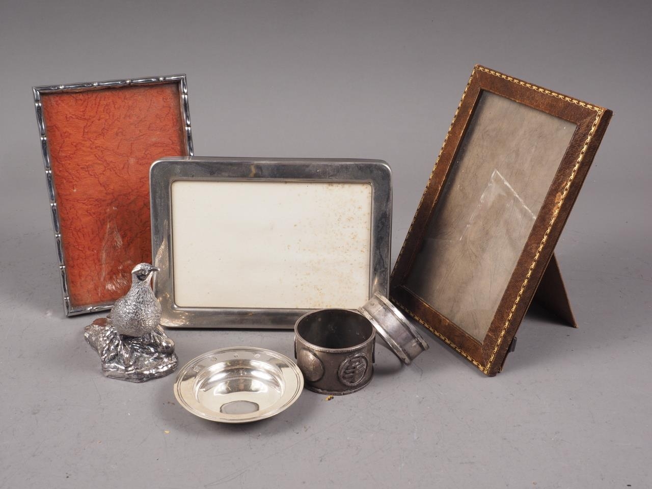 A silver model of a pheasant, a silver napkin ring, a silver miniature armada dish, a Chinese napkin