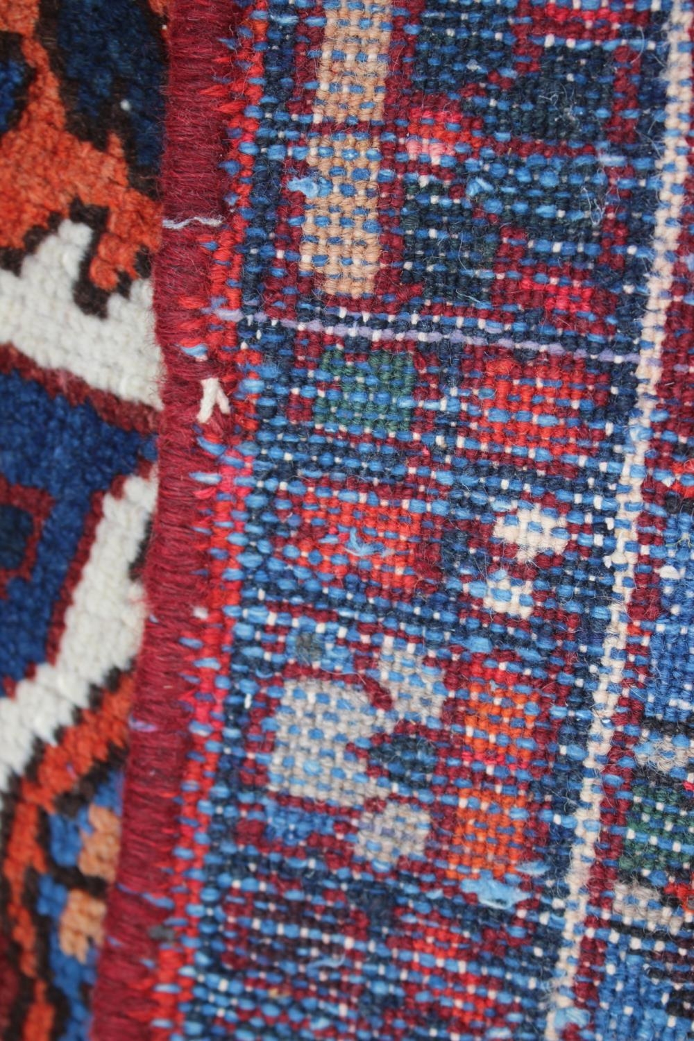 A Hamadan carpet with central star design, on a salmon ground, in shades of blue, brown, pink, - Image 12 of 14