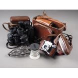A pair of Pentax 10x50 binoculars, one other pair of binoculars, a Conta flex camera, a telephoto