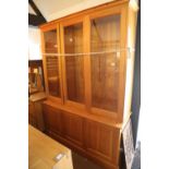 A hand-made waxed pine bookcase/display cabinet enclosed three glazed doors over three panel