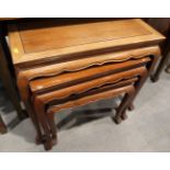 A nest of four Chinese carved hardwood occasional tables, on cabriole supports, 24" wide x 15"