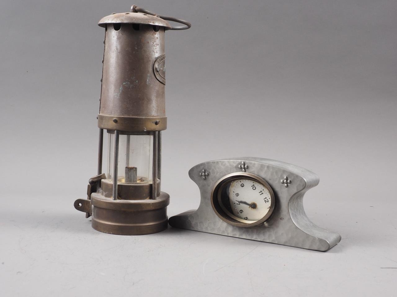 A miner's safety lamp, by Thomas Williams, and a hammered pewter cased mantel clock