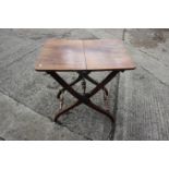 A 19th century walnut folding coaching table, on 'X' frame support, 30" wide x 22" deep x 28" high