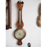 A 19th century mahogany and inlaid banjo barometer and thermometer by A Carioli