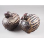 A pair of lacquered hardwood model quails, 9 1/2" high