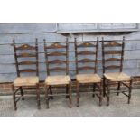 A set of four polished as walnut rush seat ladderback dining chairs