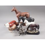 A Beswick model horse, "Arkle", on oval wooden base, 11 3/4" high, a Beswick model Hereford cow, 4