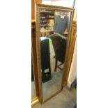 A rectangular gilt framed slip mirror, 50" x 17"