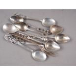 A set of four silver teaspoons with shaped handles (one damaged), three similar teaspoons, a