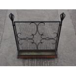 A copper planter under wrought iron grill with scrolled designs, 32" high