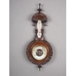 A late 19th century carved and turned mahogany cased aneroid barometer and thermometer, 18" long