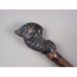 An Edwardian bamboo and carved ebony parasol handle, formed as a parrot
