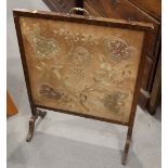 A walnut framed firescreen with embroidered panel, 23 1/2" wide, and an oak and brass mounted coal
