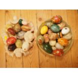 An assortment of polished hardstone eggs, three floral decorated eggs, a circular green onyx dish