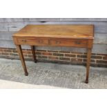 A walnut side table, fitted two drawers, on square taper supports, 44" wide x 20" deep x 30" high