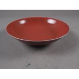 A Chinese porcelain red ground shallow bowl with twelve-character mark, 7 1/2" dia