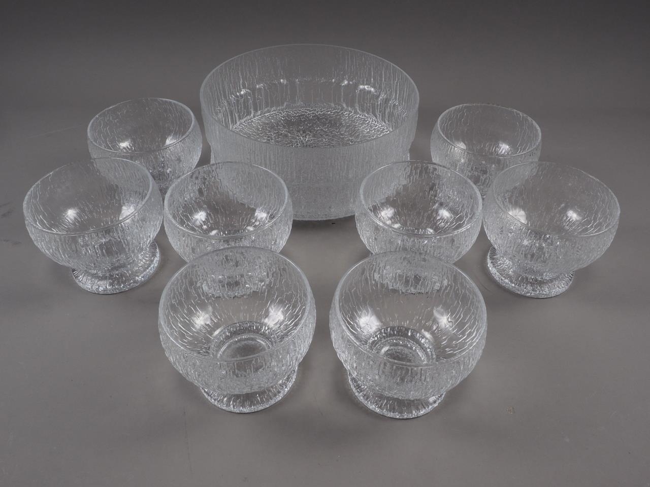 A Finnish mottled clear glass bowl, 9" dia x 4" high, and eight similar bowls, 4" dia x 3 1/2" high