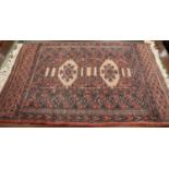 A Bokhara mat with two medallions on a faun ground and multi-borders in traditional shades, 33" x 24