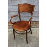 A Fischel bentwood elbow chair with panel seat and back on turned supports