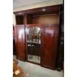 A Holland and Sons 19th century figured mahogany linen press/wardrobe enclosed mirror door and two