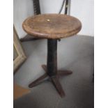 A Singer sewing machinist's panel seat chair, on cast iron base