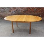 A 1960s Ercol pine oval extending dining table, on turned support, 54" x 42" x 28" high