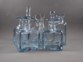 Eight Strombergshyttan clear glass decanters, various sizes and shapes