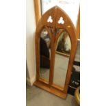 A carved and pierced oak Gothic lancet framed wall mirror with shelf, 45" high x 22" wide overall