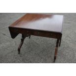 An early 19th century mahogany and banded sofa table, fitted two drawers with brass ring handles, on