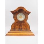An early 20th century figured walnut shape top mantel clock with gilt dial, 10 3/4" high