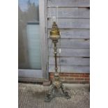 A 19th century brass openwork standard lamp, on tripod scroll support