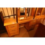 An Ercol light oak dressing table, fitted six drawers and swing frame mirror over, 58" wide x 19"